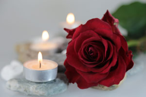 single rose by a tealight candle